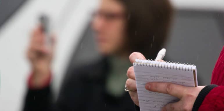 A close-up of a journalist's notebook as they are taking notes.